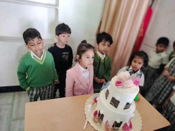 Friends gather around the birthday cake